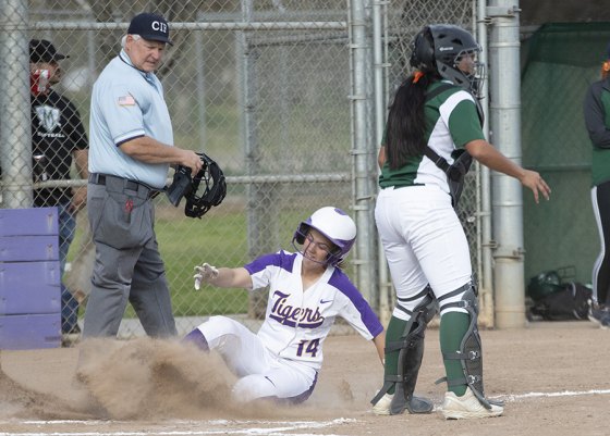 Lemoore's Shelly Jobe slides safety at home in Wednesday afternoon's 12-11 victory over visiting El Diamante.
